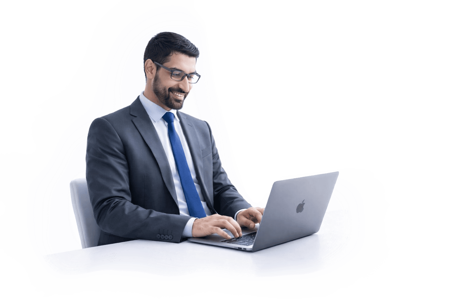 A business professional with glasses smiling and typing on a laptop to register for KIRA's hybrid partnership program.