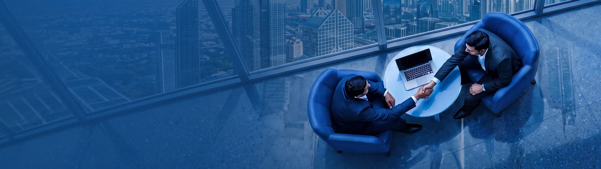 Two business partners shaking hands in a high-rise office